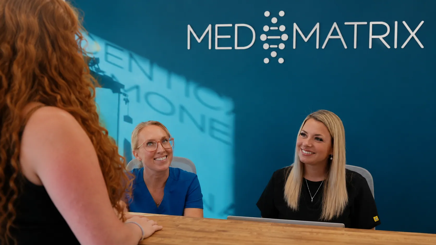 Med Matrix front desk staff greeting a patient at our South Portland, Maine clinic