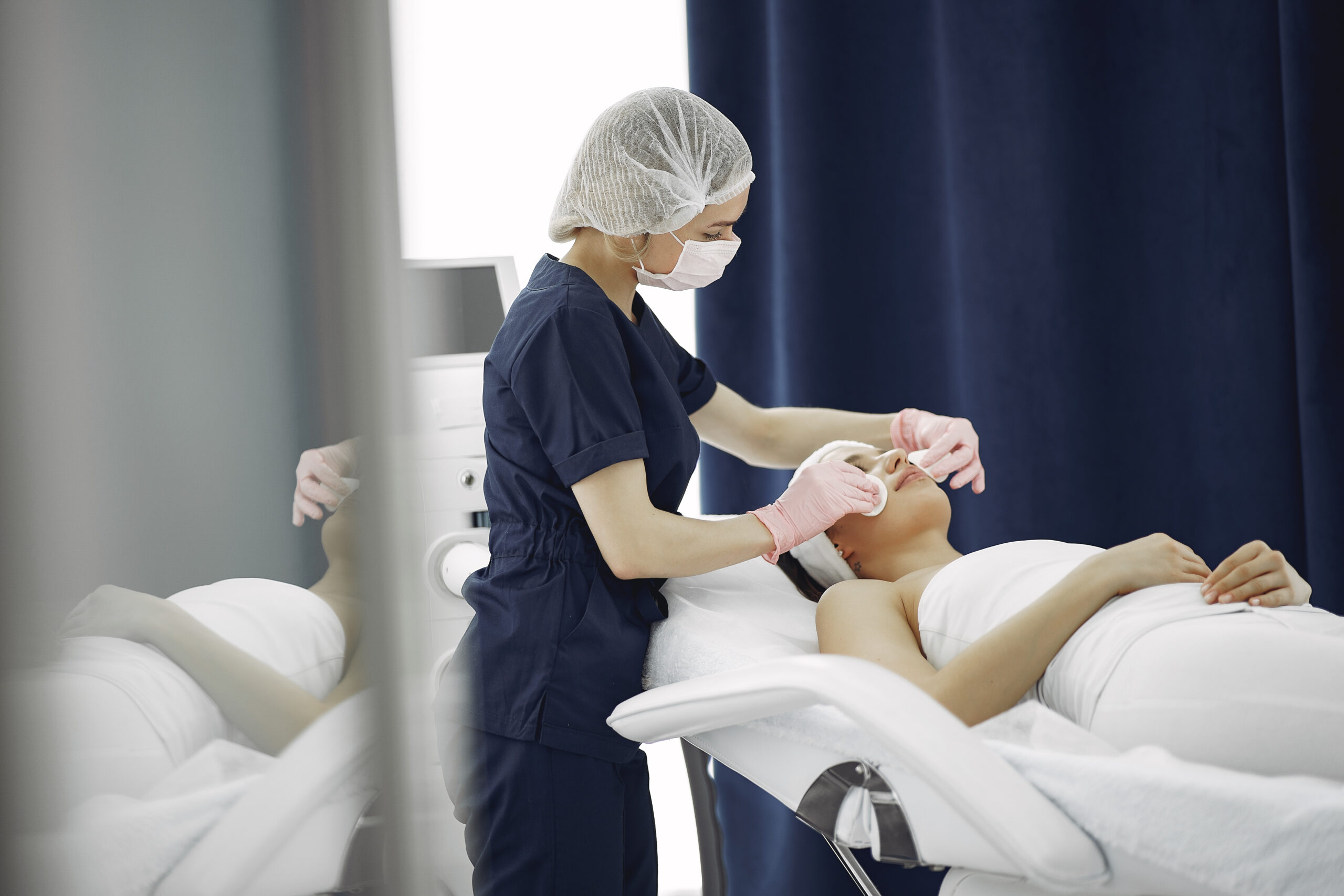Cosmetologist treats client's skin. Woman with cosmetologist. Lady in a beauty studio.
